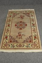 A Chinese style rug, with beige ground. L.163 W.92cm.