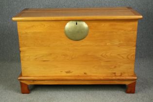 An elm lidded chest on stand, in the Chinese taste. H.92 W.135 D.62cm.