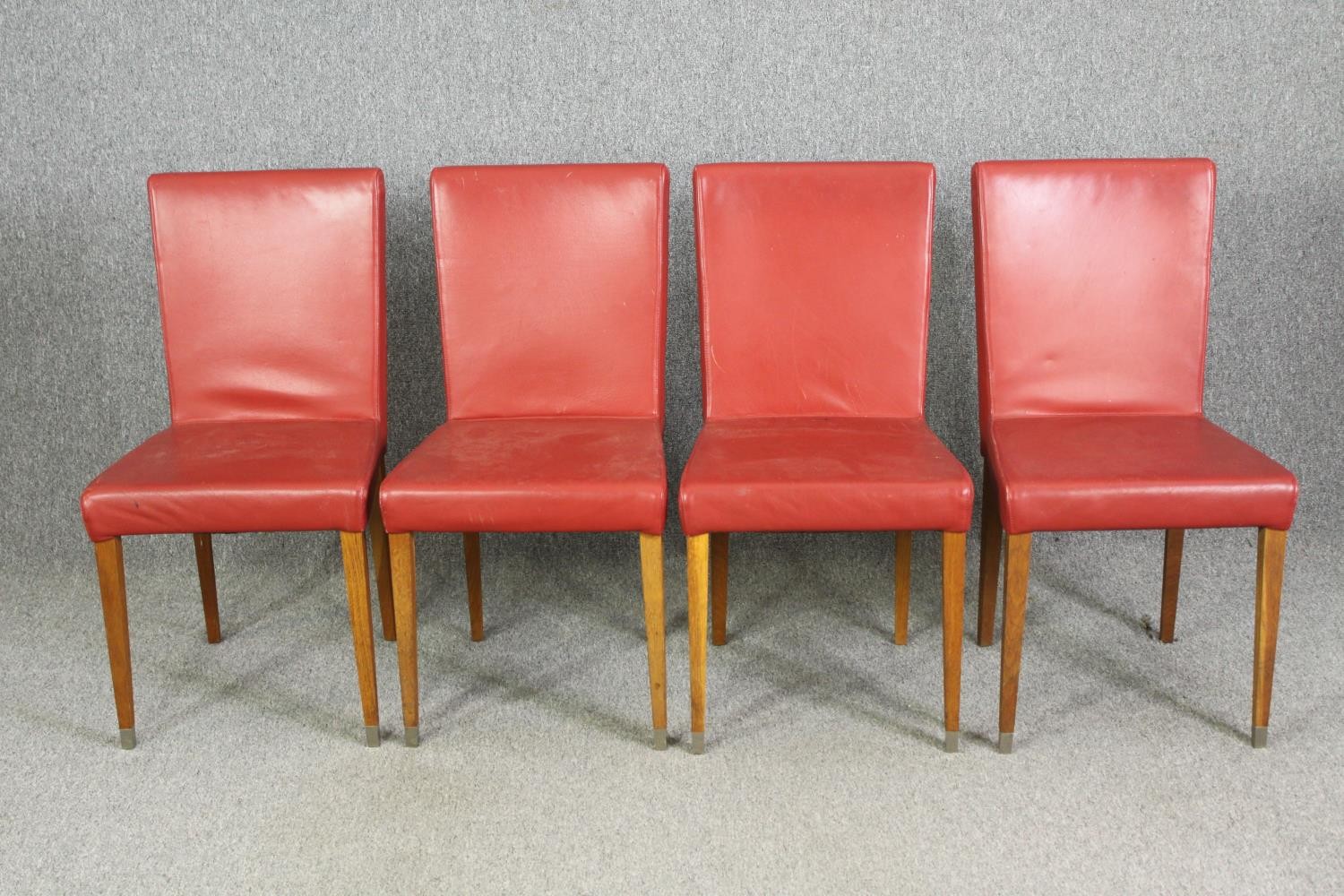 A set of four leather upholstered dining chairs. H.90cm. (each).