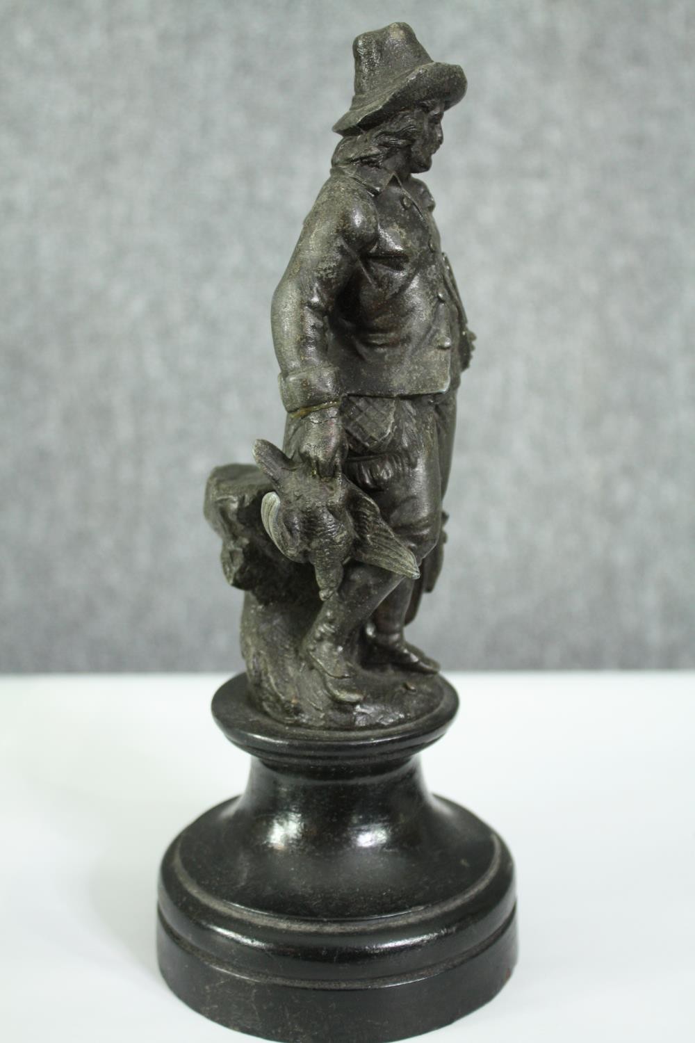 Two 19th century spelter figures of a huntsman and fisherman. H.25cm. (each). - Image 6 of 8