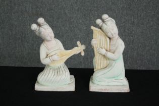 Two Chinese Tang Dynasty style white painted terracotta female musicians. H.27cm. (each).