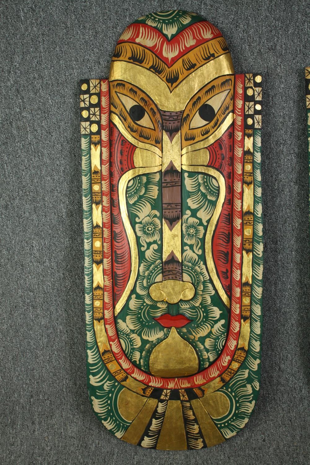 A pair of Indonesian painted head masks, with other smaller associated carvings. L.103 W.42cm. ( - Image 3 of 8