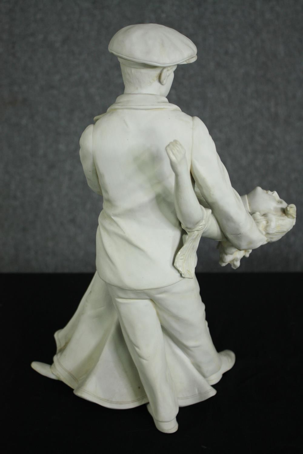 A white bisque porcelain figural group of an early 20th century man and woman dancing. H.39cm. - Image 4 of 7