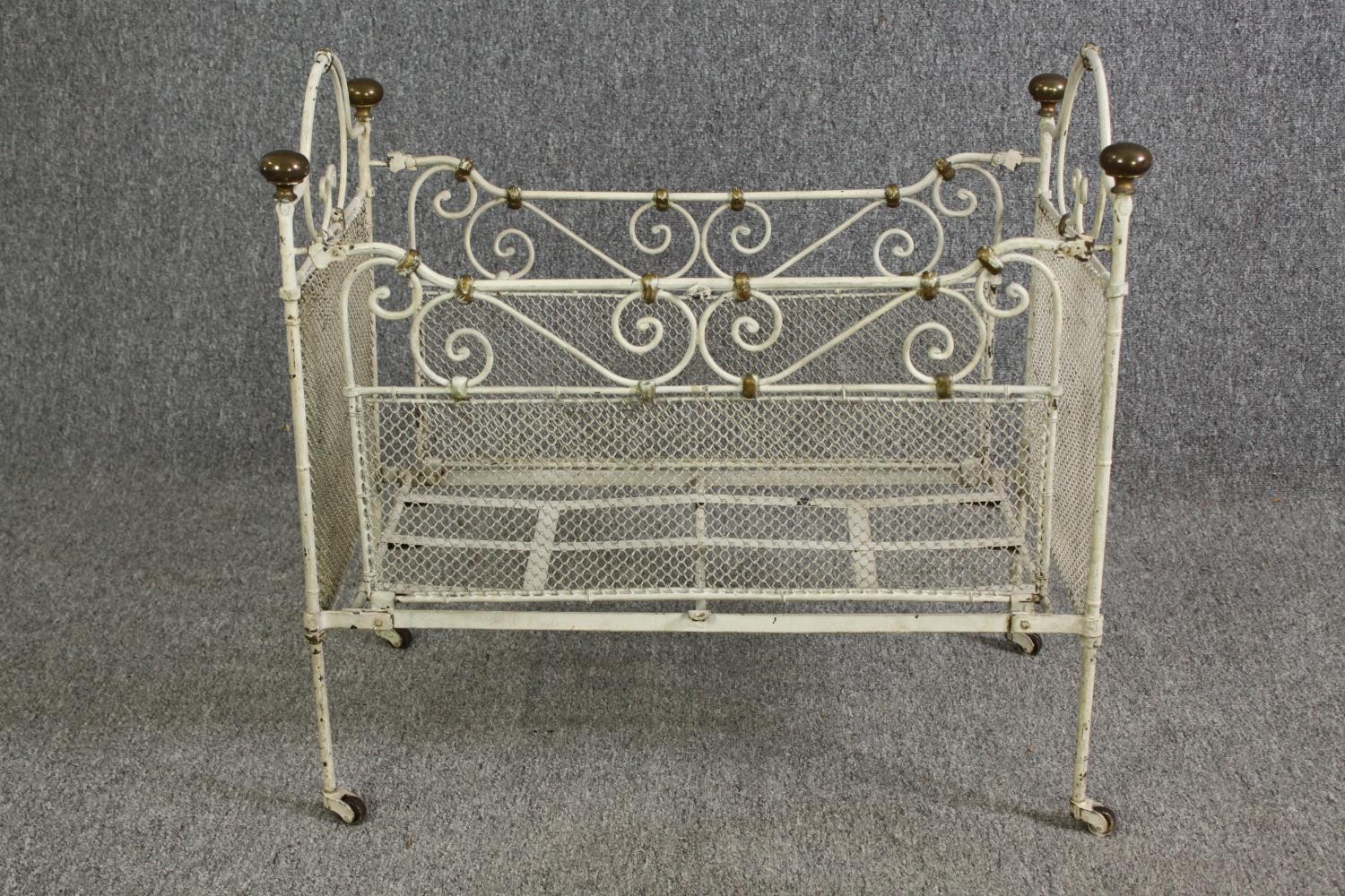 A white painted metal and brass cot, early 20th century. H.64 W.69 D.38cm. - Image 2 of 9