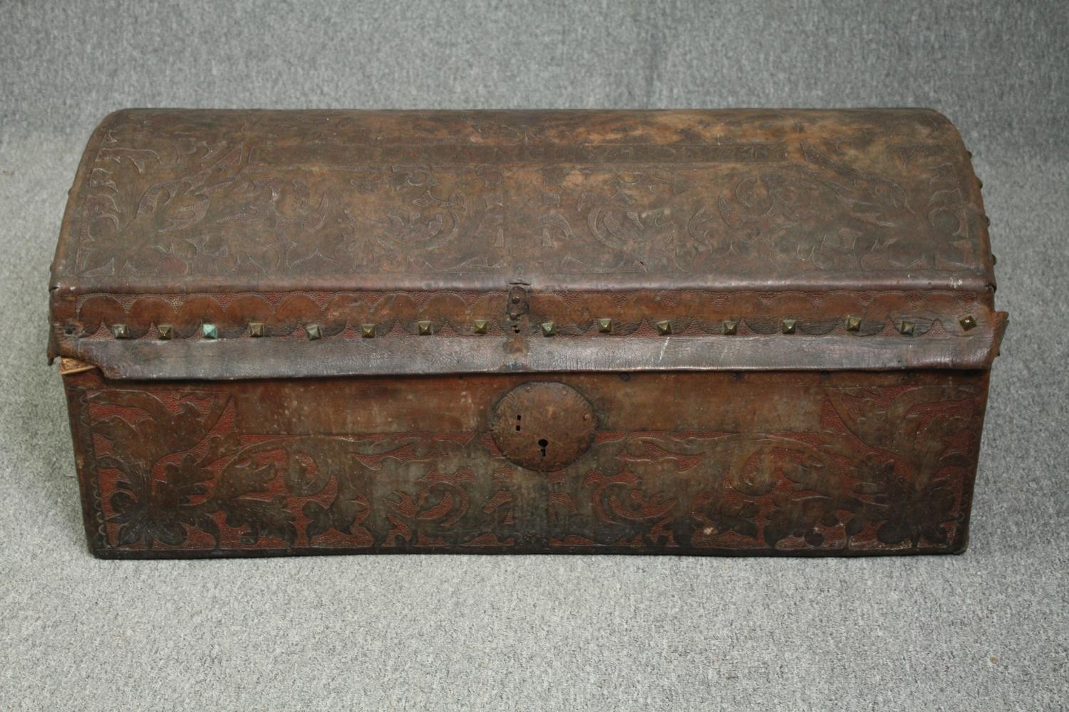 Travelling trunk, 19th century studded embossed leather. H.47 W.110 D.54cm.