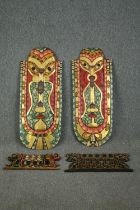 A pair of Indonesian painted head masks, with other smaller associated carvings. L.103 W.42cm. (