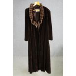 A Debenham and Freebody, London, vintage velvet and fur collared evening coat. Makers label to