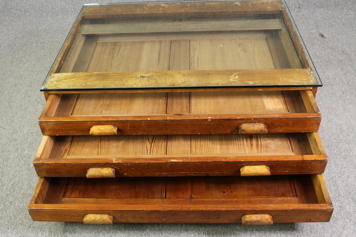 A 1920's pine planners chest, with later glass top to form a coffee table. H.40 W.123 D.92cm. - Image 6 of 8