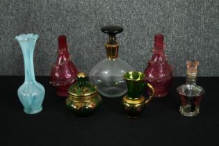 A group of Bohemian glass vessels, including a green lidded jar and vase with gilded and enamelled