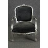 A small Louis XV style silver painted child's armchair. H.67cm.