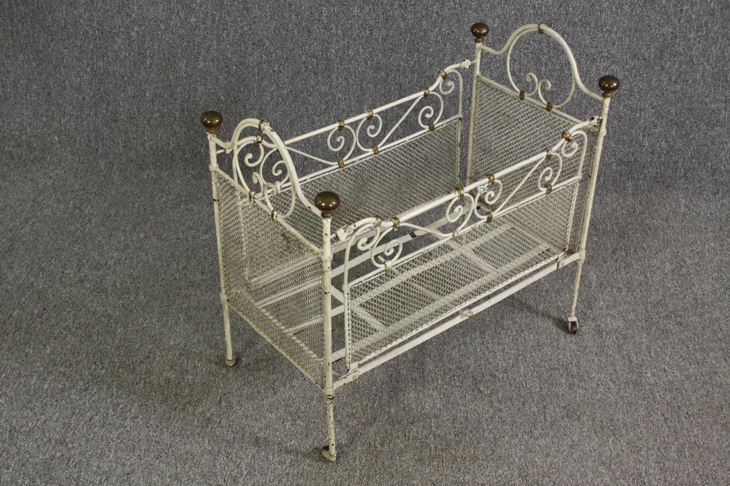 A white painted metal and brass cot, early 20th century. H.64 W.69 D.38cm. - Image 3 of 9