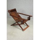 A Chinese carved hardwood folding chair, 19th century. H.78 W.112 D.59cm.