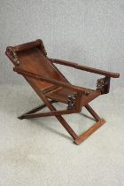 A Chinese carved hardwood folding chair, 19th century. H.78 W.112 D.59cm.