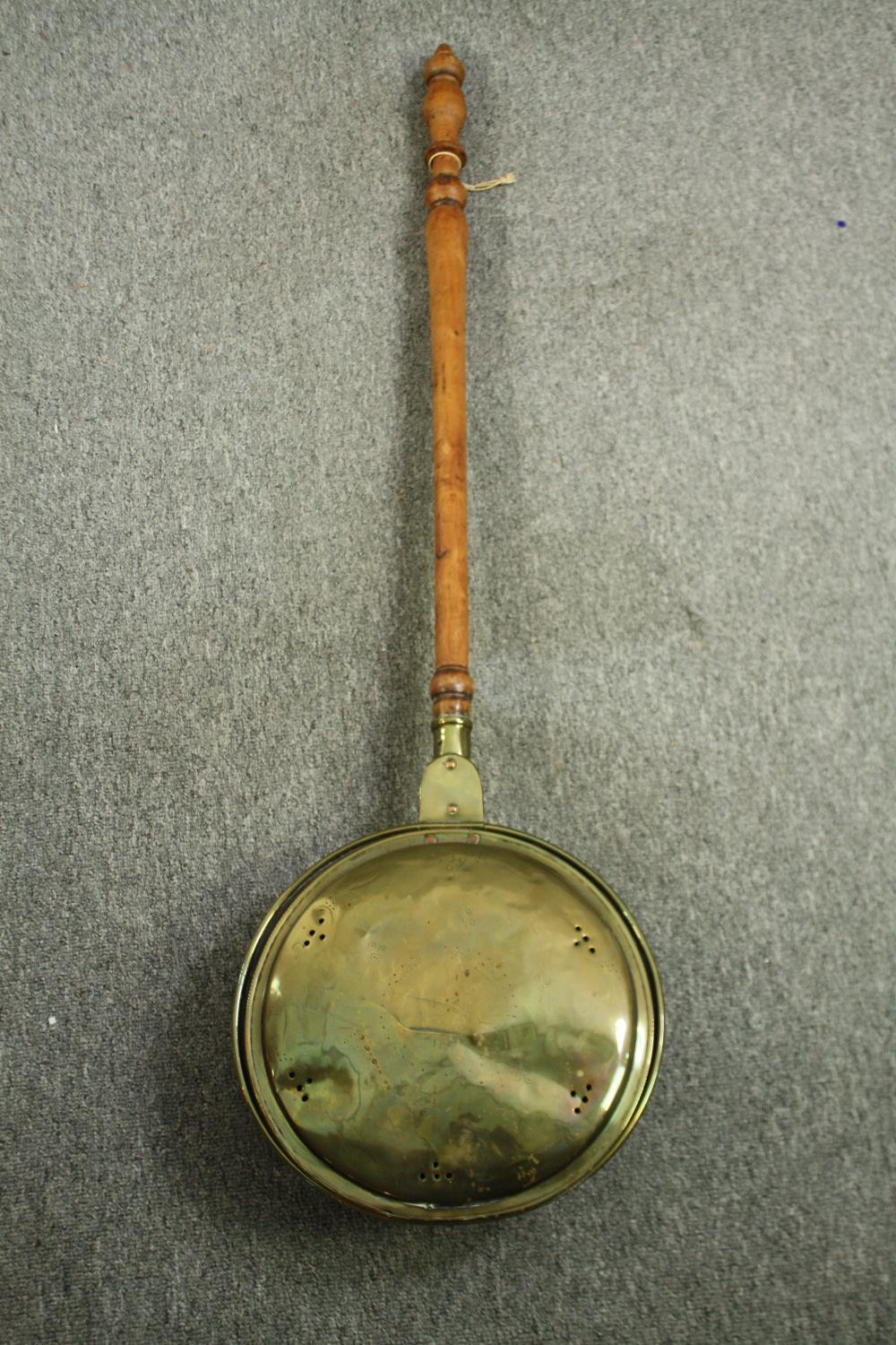 A late 19th century brass bed warming pan. L.99cm.