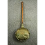 A late 19th century brass bed warming pan. L.99cm.