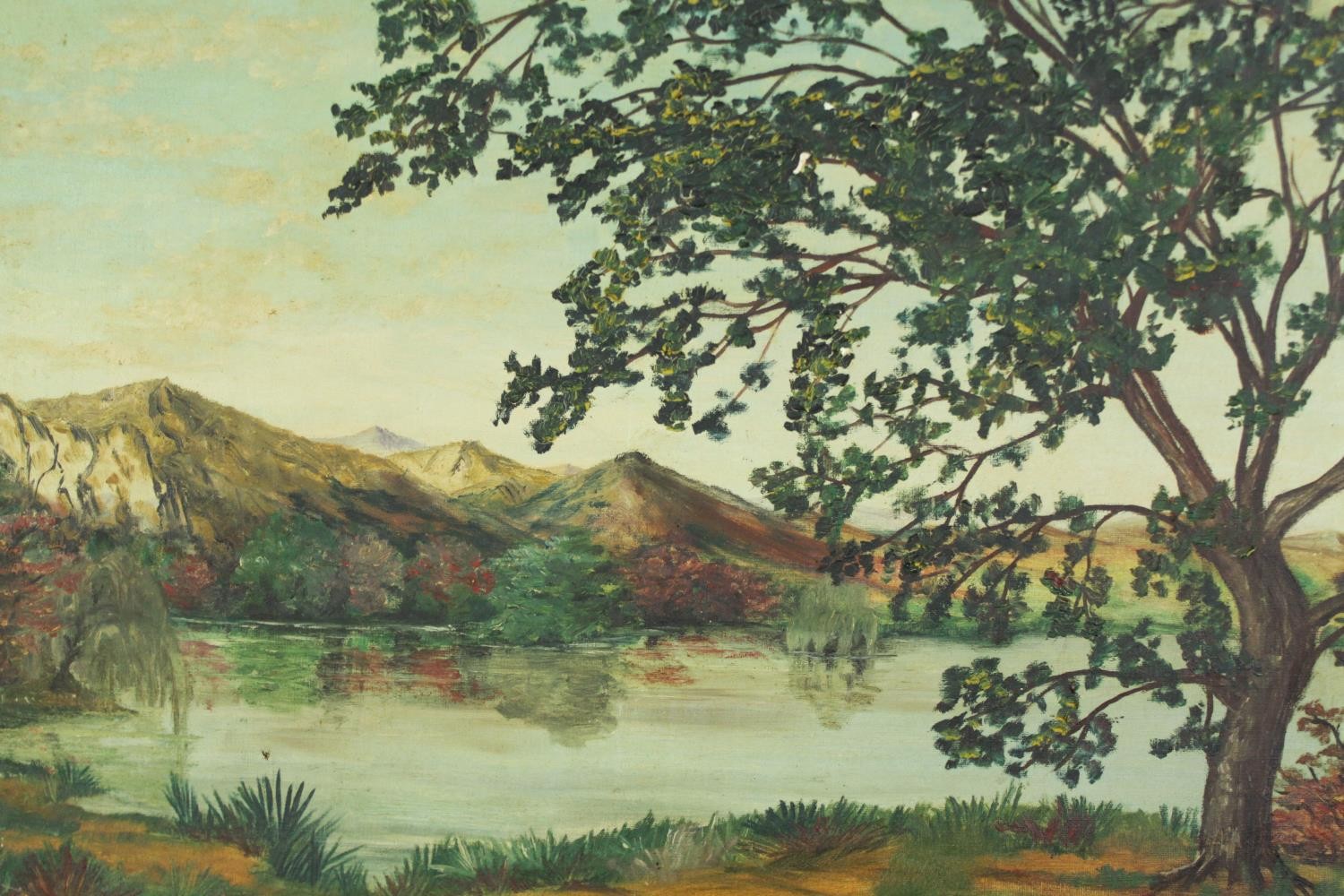 An oil on canvas, a lake and hills signed Paradis, 20th century. H.47 W.65cm.