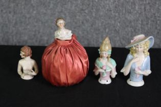 WITHDRAWN- A group of four ceramic doll pin cushions. H.13cm. (largest).