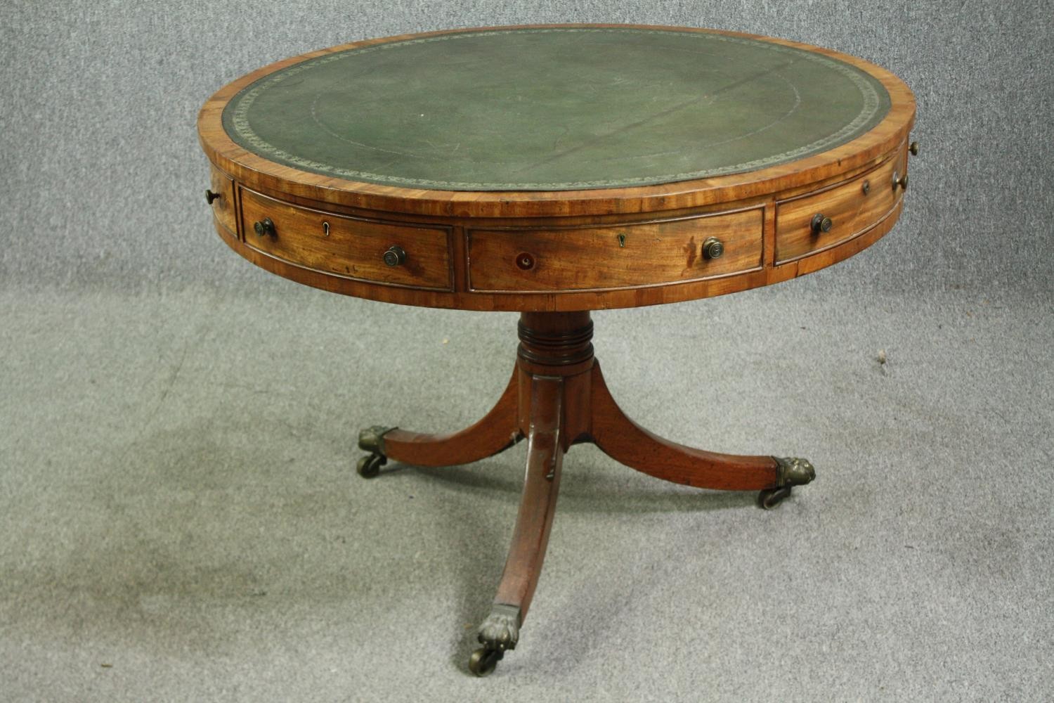 A Regency mahogany drum top library table, with a green tooled leather inset top, 19th century. H.76