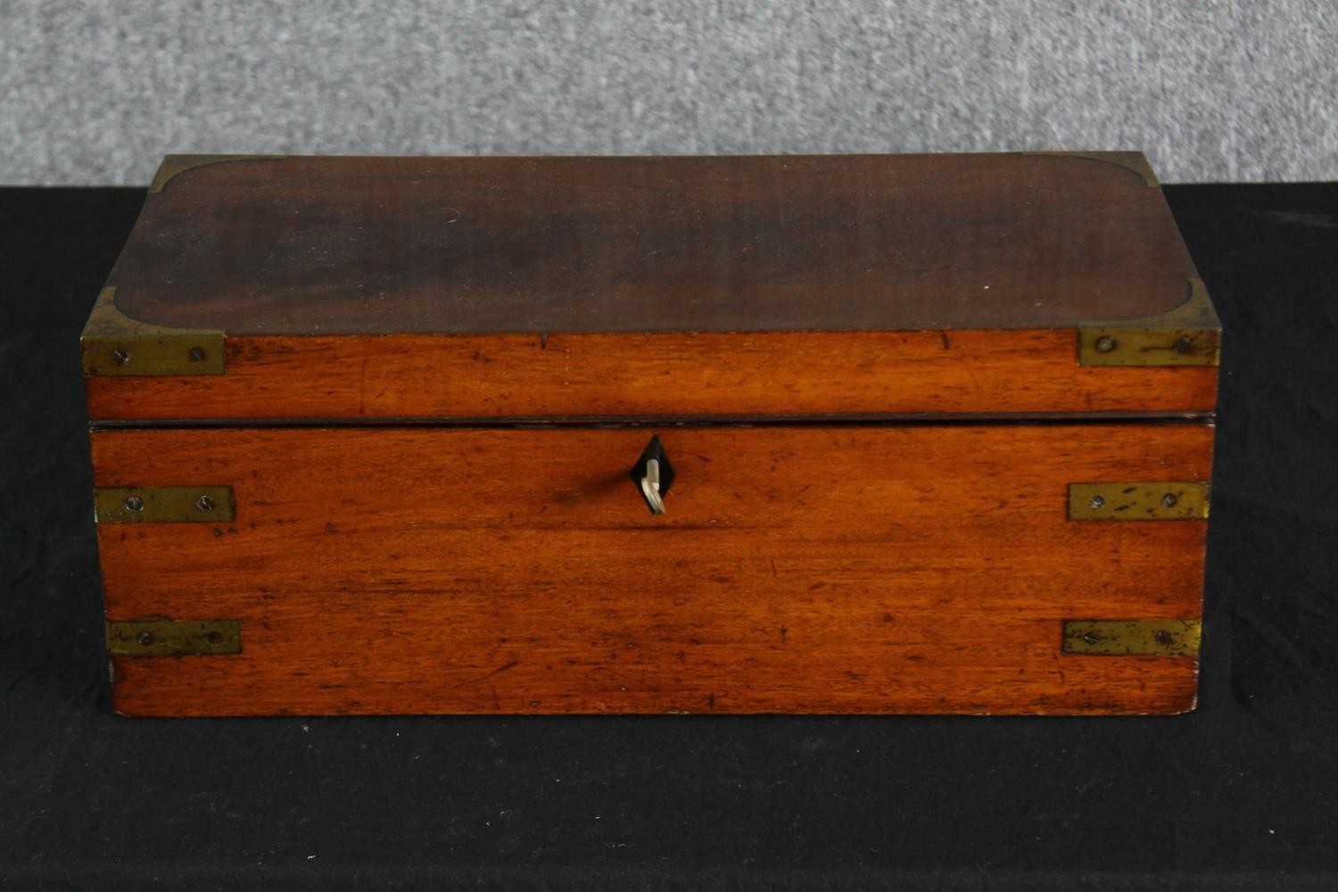 A Victorian mahogany and brass mounted writing slope, with a red leather fitted interior. H.18 W.