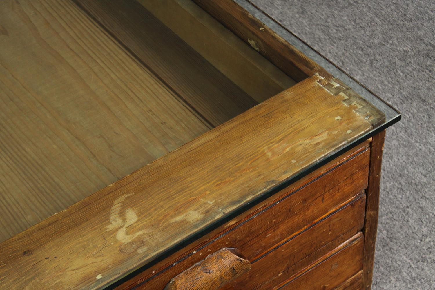 A 1920's pine planners chest, with later glass top to form a coffee table. H.40 W.123 D.92cm. - Image 5 of 8