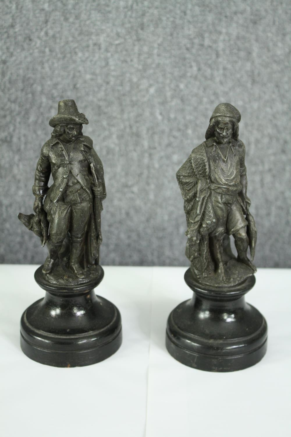 Two 19th century spelter figures of a huntsman and fisherman. H.25cm. (each).