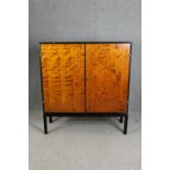 Hall cupboard or linen cabinet on stand, mid century ebonised and section veneered birch. H.139 W.