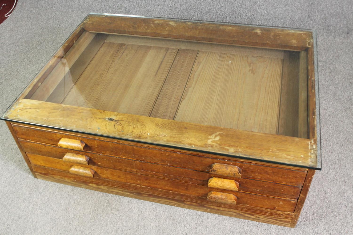 A 1920's pine planners chest, with later glass top to form a coffee table. H.40 W.123 D.92cm. - Image 3 of 8