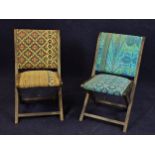 A pair of vintage upholstered folding chairs with teak frames.