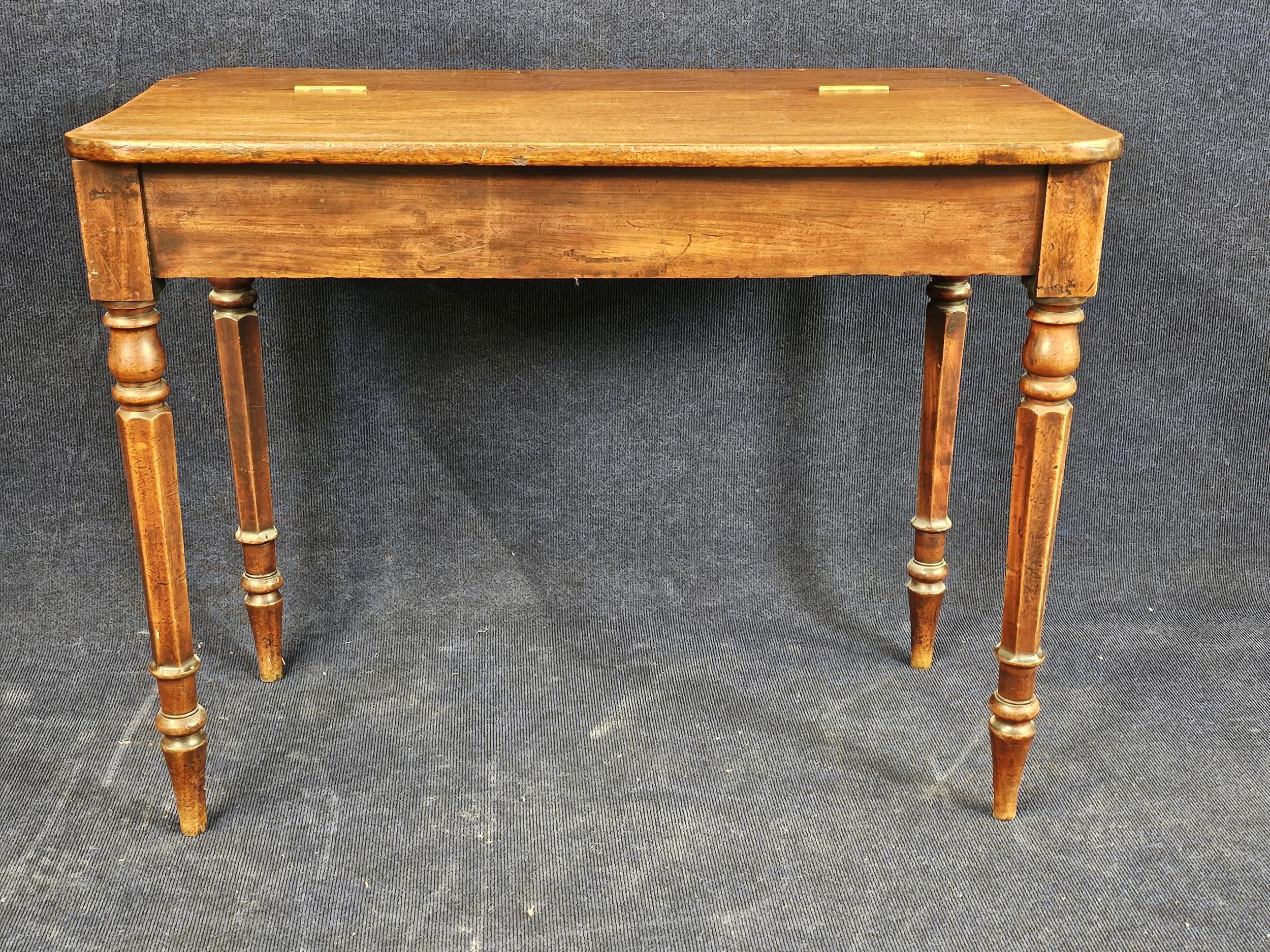 A George IV mahogany side table with hinged lid. H.75 W.95 D.52cm.