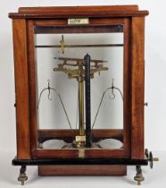 A set of early 20th century balance scales by Oertling (model number 48G.C.) in a mahogany case. H.