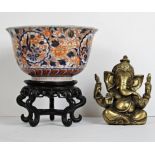 An Imari Bowl on stand and a heavy brass statue of Ganesha. Bowl is D.19cm.