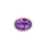 A Victorian yellow metal (tests as higher than 14ct) amethyst and seed pearl brooch, set to centre
