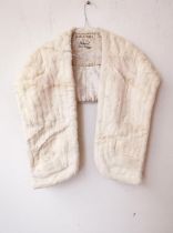 A vintage white mink fur sole with front pockets, with designer label 'National Fur Co Ltd. and