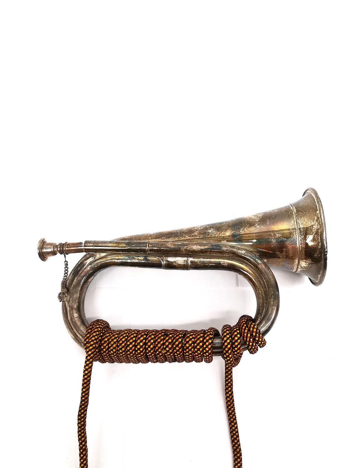 A silver plated bugle with red black and yellow silk rope with tassel ends. L.28 W.19cm - Image 4 of 4