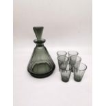 A Czechoslovakian Art Deco smoky faceted conical glass decanter with six matching shot glasses.