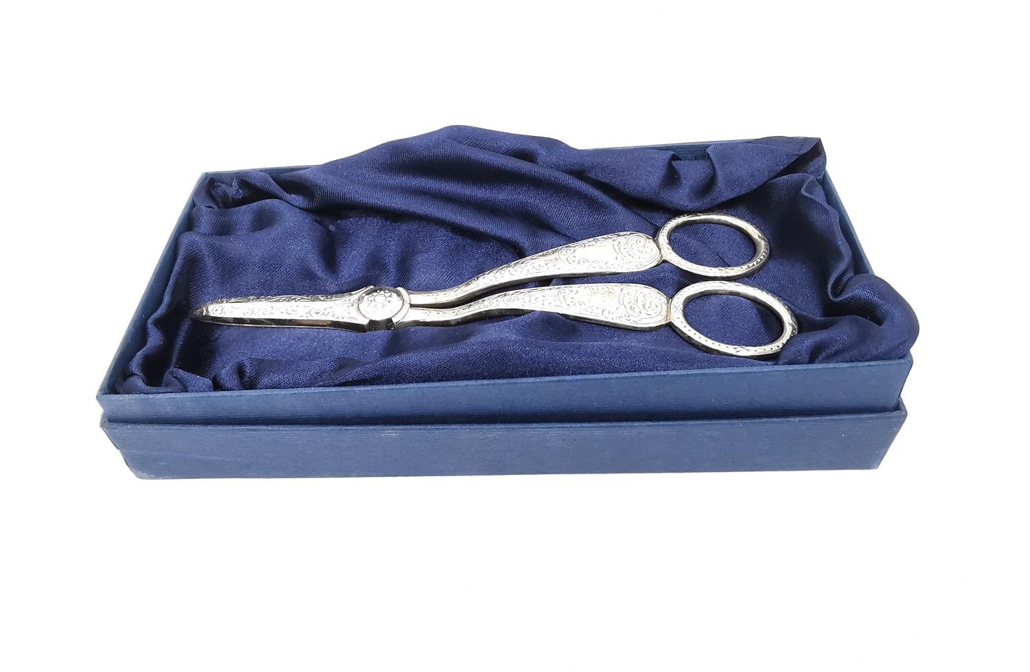 A pair of Victorian engraved silver grape scissors by Henry Atkins decorated with scrolling