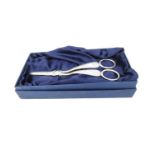 A pair of Victorian engraved silver grape scissors by Henry Atkins decorated with scrolling