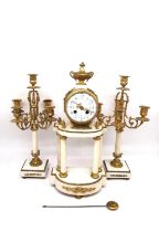 A 19th century Louis XVI style white marble and gilt metal mantel clock with twin candelabra