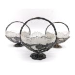 A collection of three silver plated sculptural vine and grape design sugar bowls with frosted cut