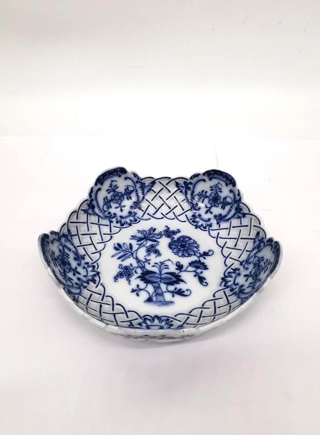 A blue on white ground 'blue onion pattern' pierced Colln Meissen dish. Diameter 15.5cm