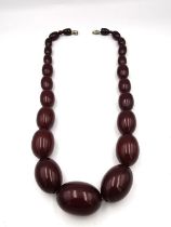 An early 20th century Cherry amber graduated oval bead necklace. (clasp has been replaced) Largest