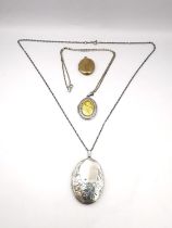 Three lockets, two silver and one 9ct gold front and back with engraved scrolling design. Longest