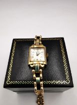 A Roamer ladies automatic vintage 9ct gold wrist watch with ladder link articulated bracelet with