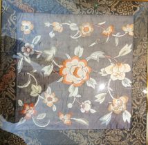 A framed and glazed early 20th century Chinese silk embroidery of flowers, with a silk brocade
