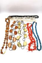 A collection of costume necklaces, including branch coral necklace, a faceted rock crystal bead