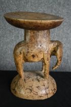 † A Cameroon carved hardwood elephant stand. H.32 Dia.23cm.