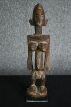 † A carved African tribal maternity figure, Bamana people, Mali. H.45cm.