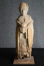 † A 19th century Chinese carved figure of a monk in traditional robes. H.77cm.