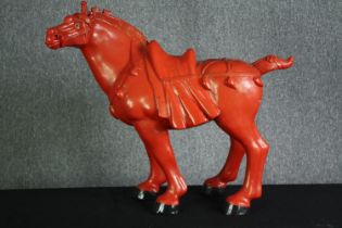 † A Chinese carved cinnabar lacquer figure of a war horse with saddle and reins. H.76 W.87cm.