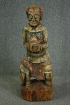 † A 19th century Chinese carved and painted figure of a warrior in traditional robes. H.110cm.